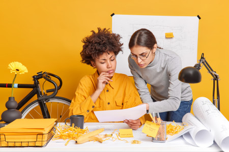 two women thinking about their business plans.