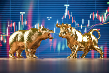 Golden bull and bear on stock data chart background.