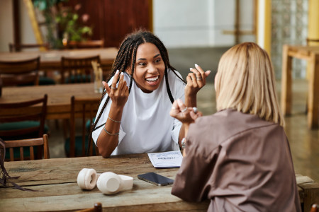 Two women chatting in a cafe.