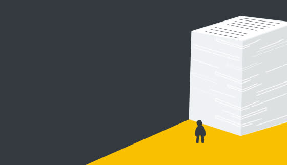 A person looking up at a mountain of paperwork