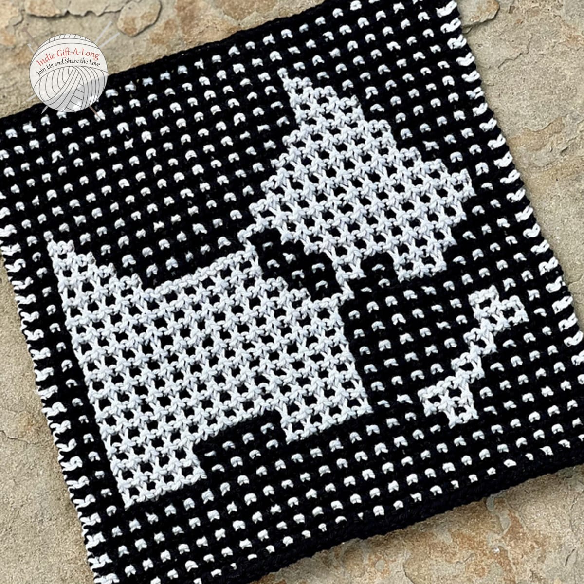 Knitted dishcloth with scottie dog motif.