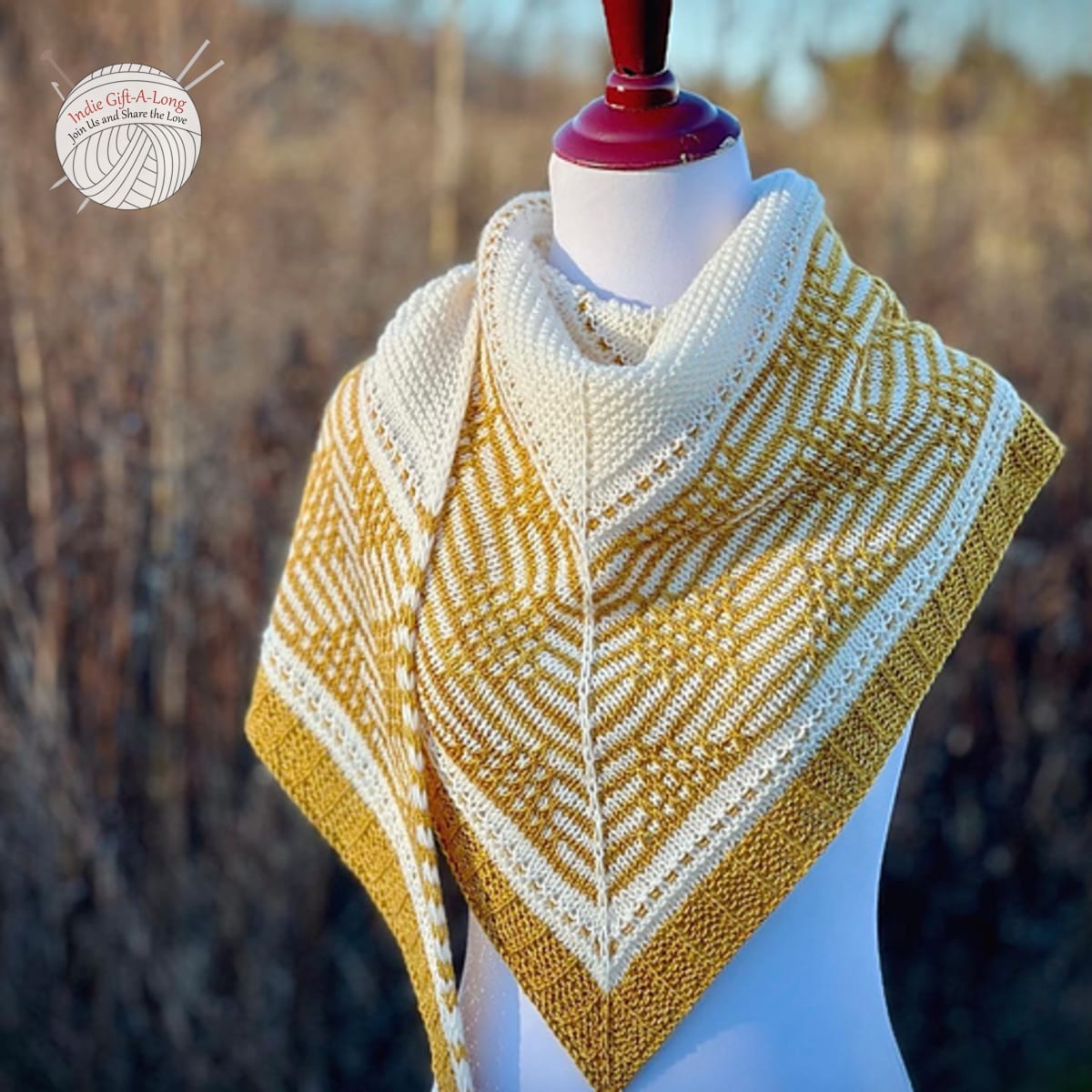 White and yellow knitted shawl with geometric motif.