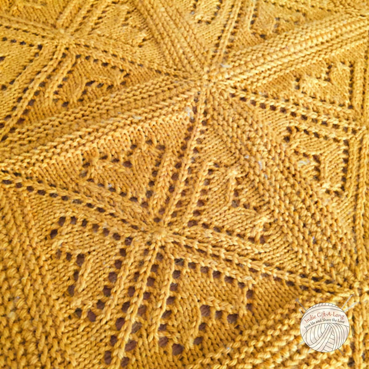 Yellow knitted blanket with lace heart motifs.