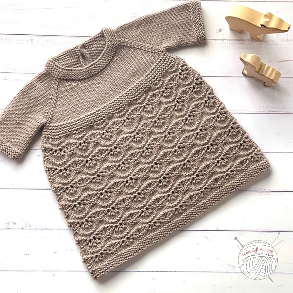 Child-sized knitted top with wavy lace texture details.