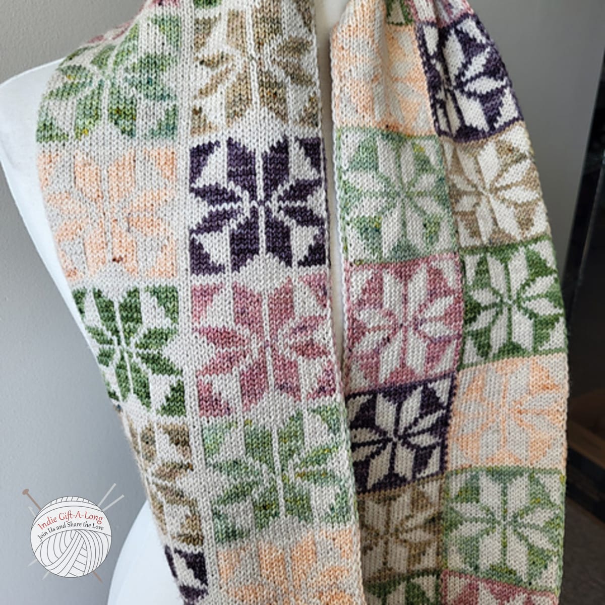 Knitted scarf with traditional quilt motifs.