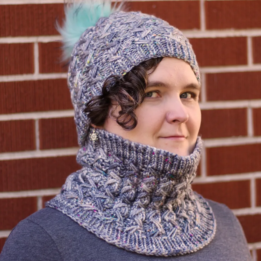 Woman wearing matching grey ribbed and textured knitted cowl and toque.