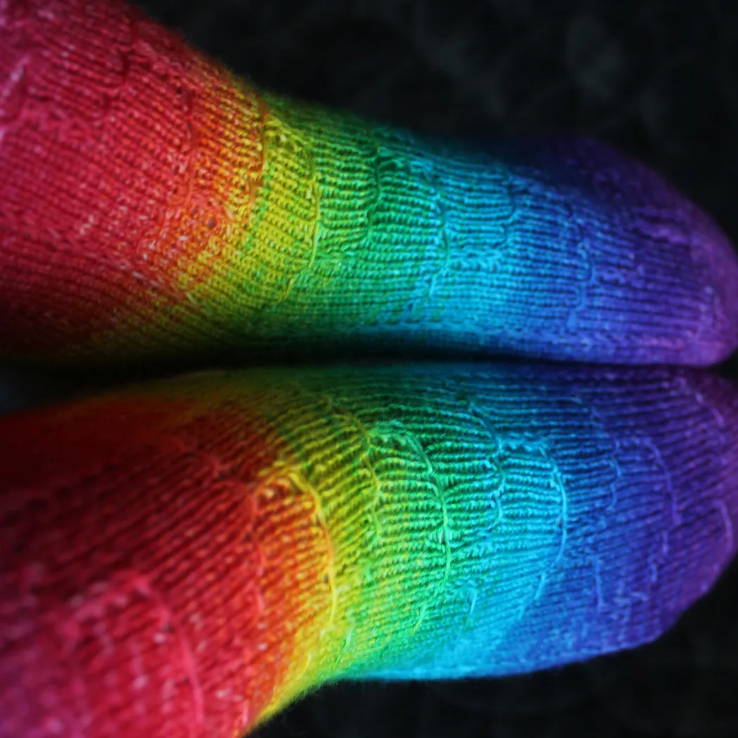 Top-down view of rainbow socks with subtle surface detail.