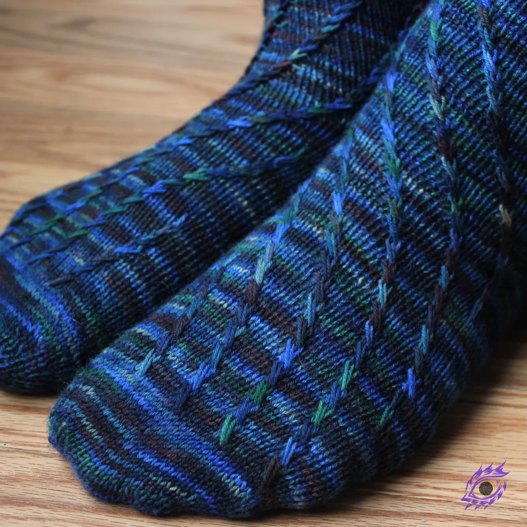 Close-up side view of dark blue socks with criss-crossing surface detail.