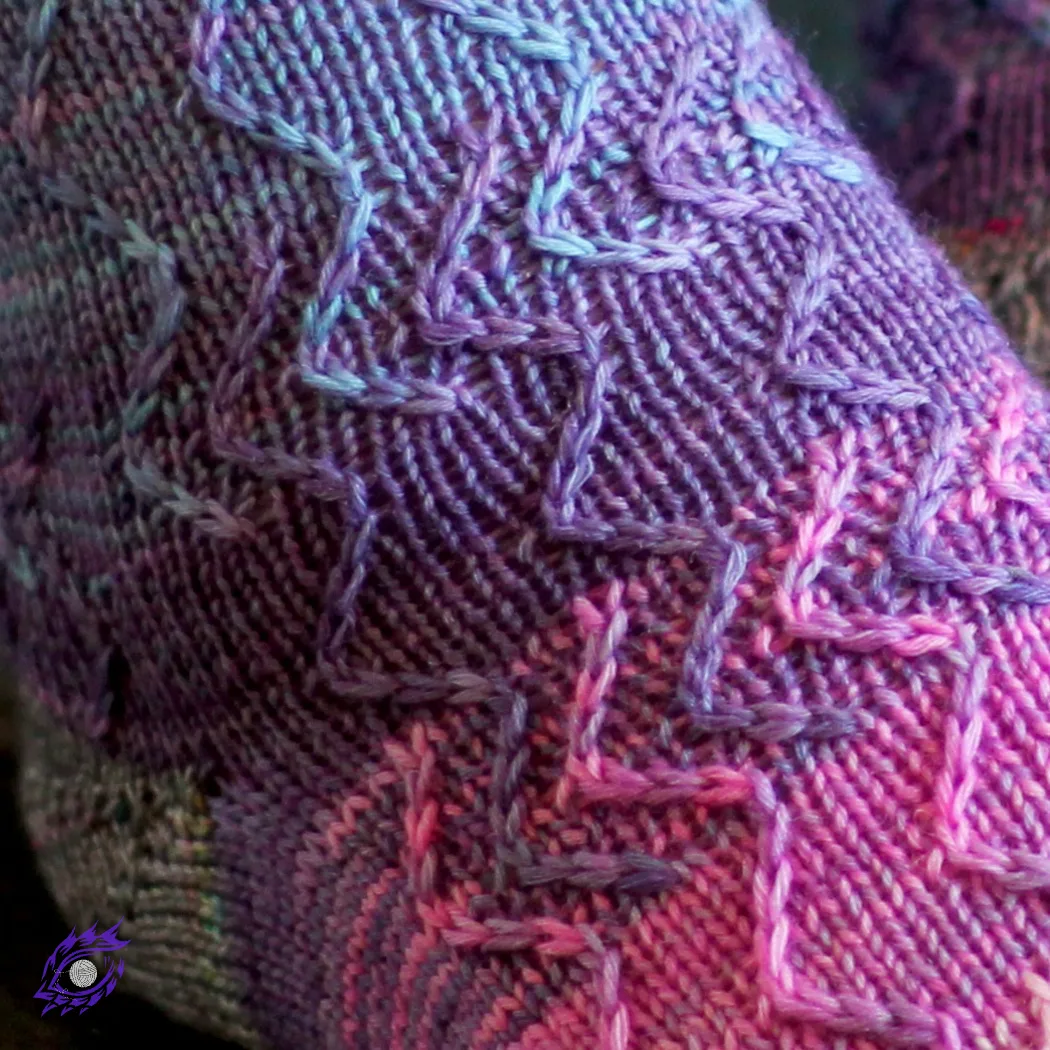 Close up of zigzag texture on blue, purple, and pink knitted socks.