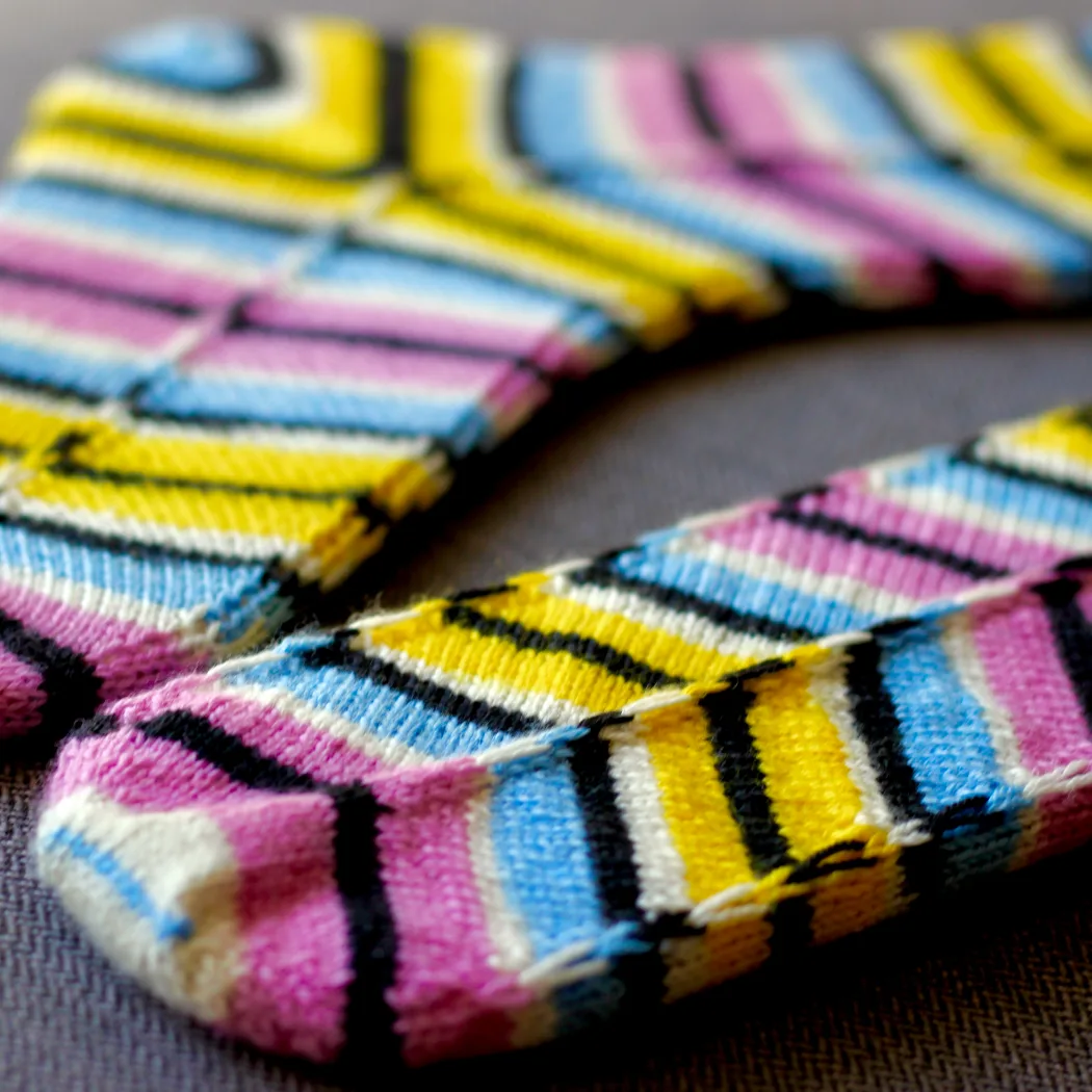 Striped knitted socks on sock blockers with graphic distorted diagonal pattern and matching heel.