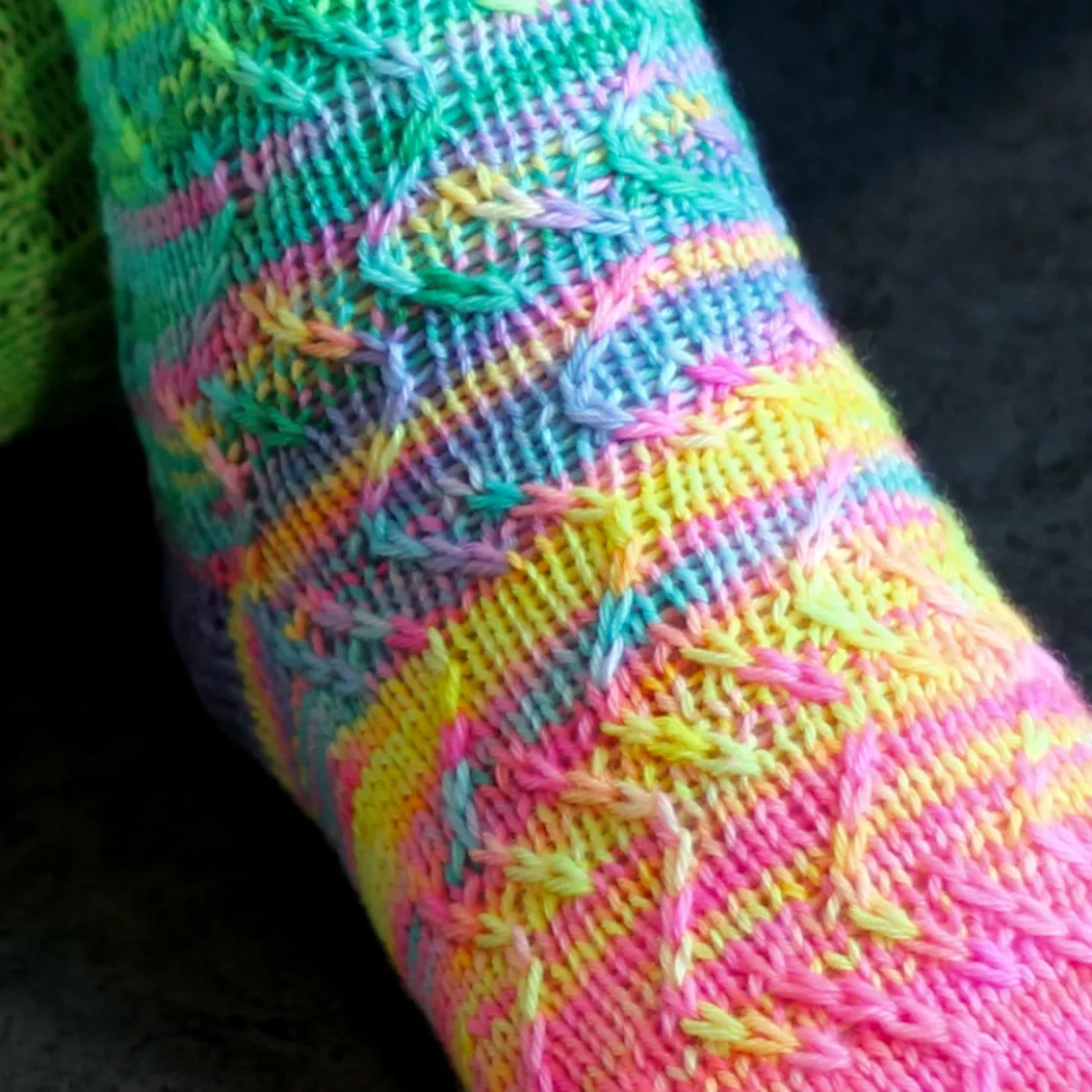 Close up of neon rainbow socks with zigzag surface texture.