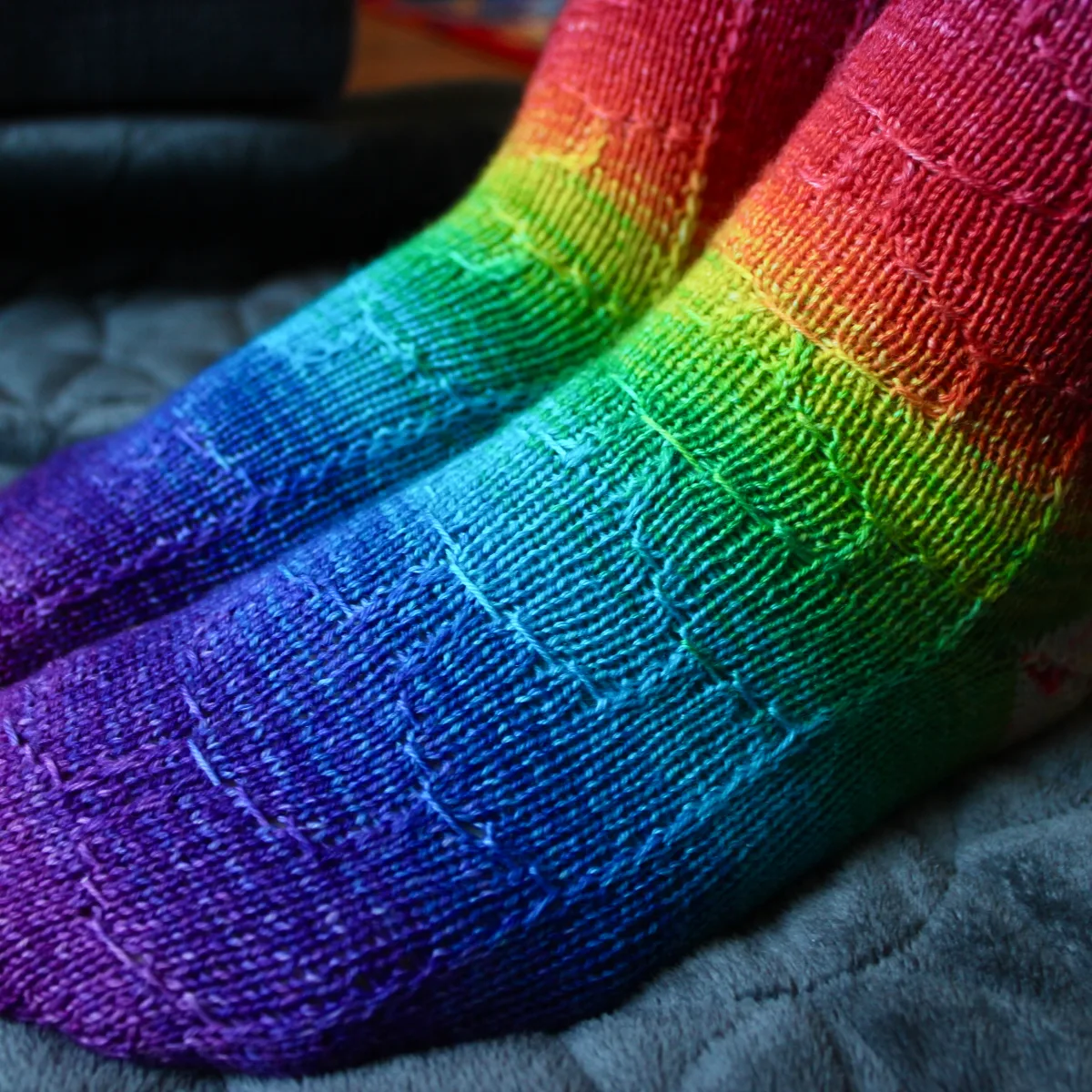 Side view of rainbow socks with subtle surface detail.