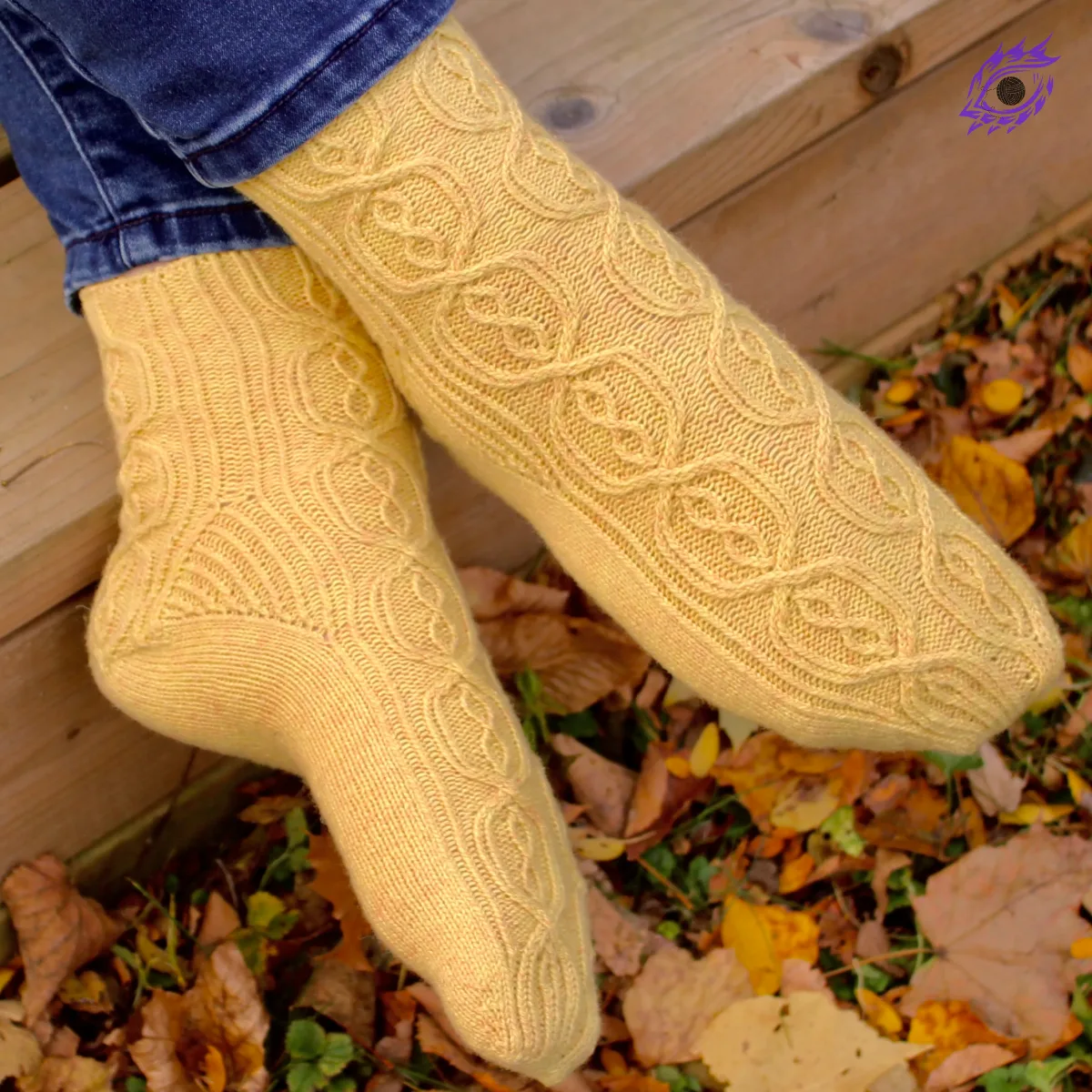 Crossed feet wearing yellow knitted socks with complex cable motif and twisted-rib accents.