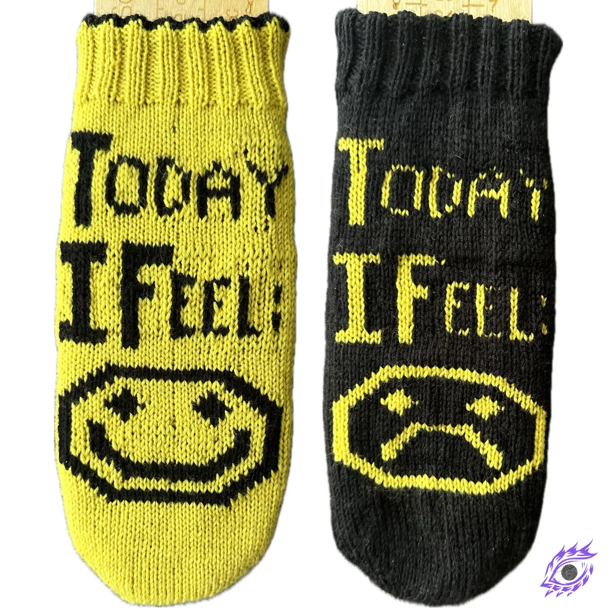 Yellow and black knitted socks with graphic happy and sad face motif and text "Today I Feel".