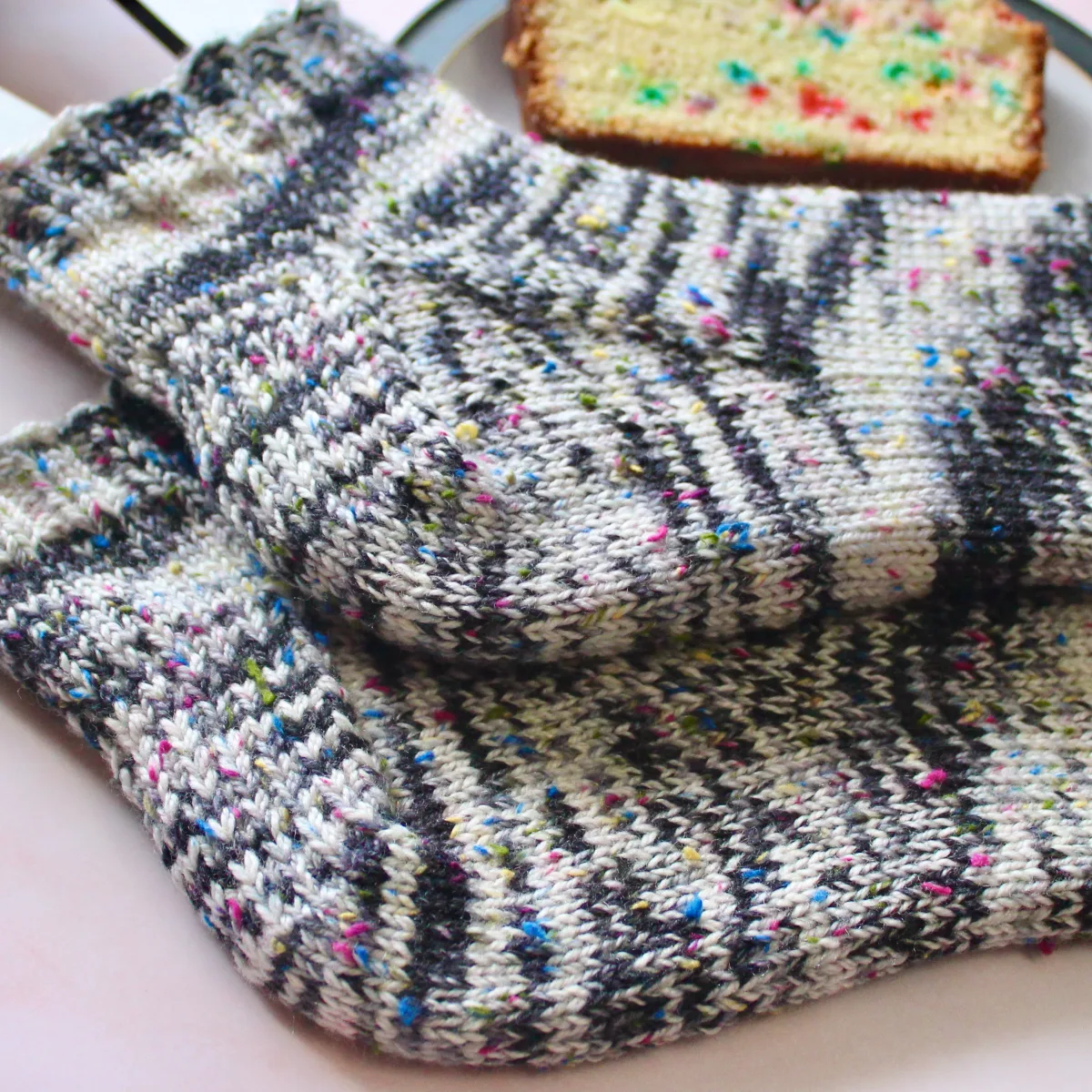 Close view of heel and gusset of black and white heavyweight socks with rainbow flecks on sock blockers.