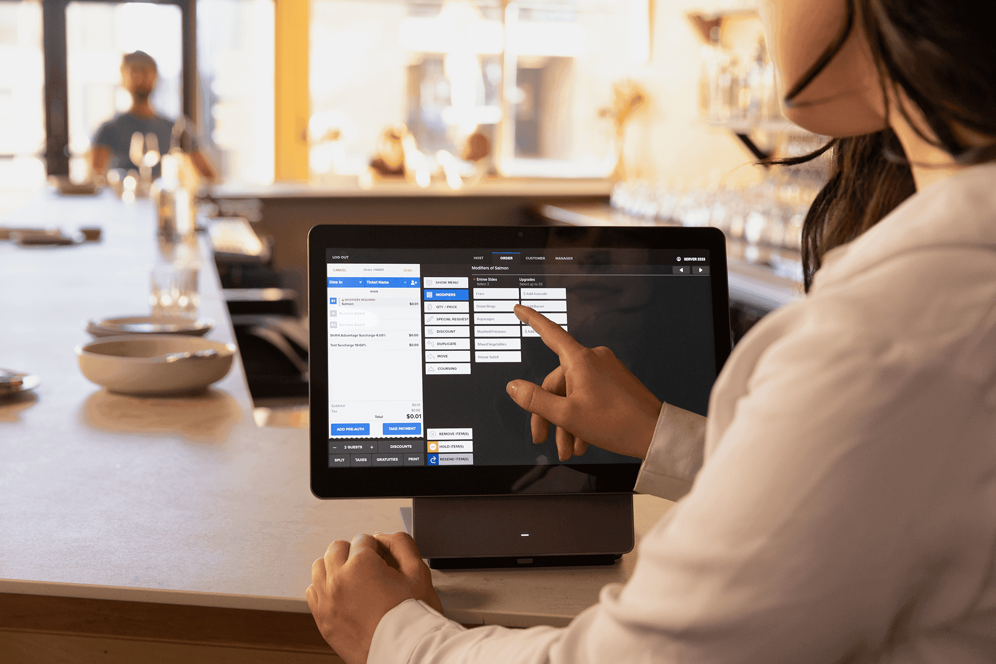 Woman using a SkyTab POS countertop workstation in a restaurant - SkyTab