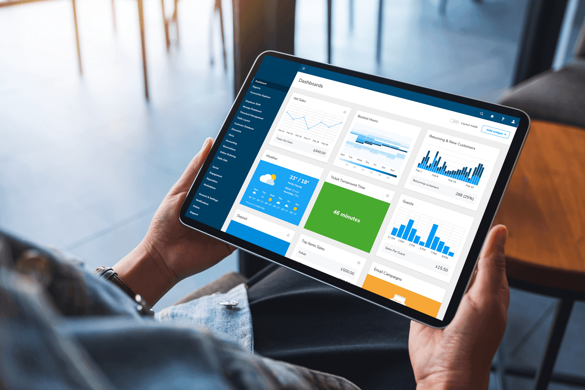 Person holding a tablet with Lighthouse Business Manager showing