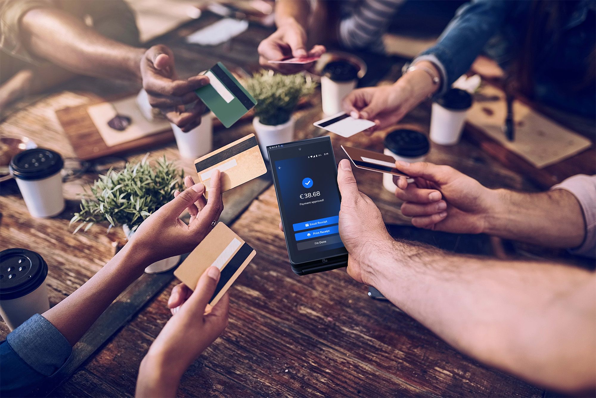 Customers at a restaurant table using their cards for tap to pay on a SkyTab Mobile POS device