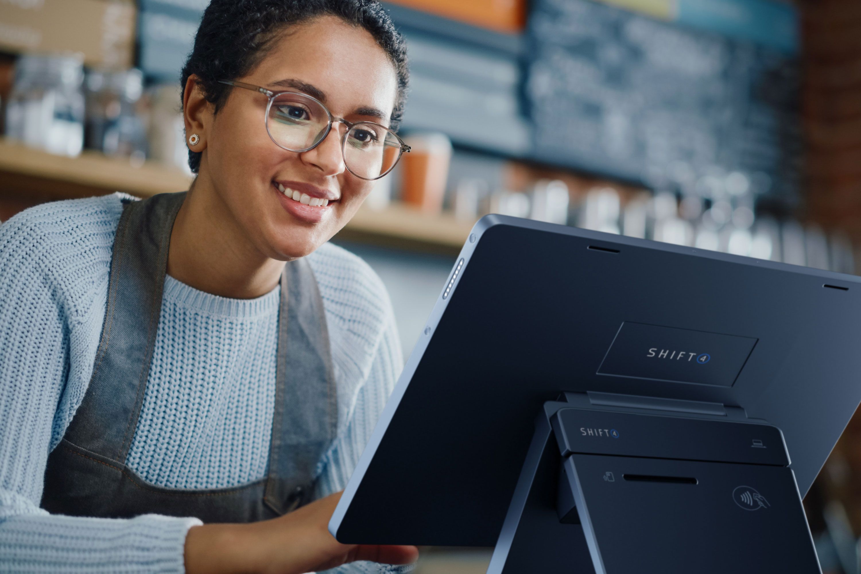 A restaurant employee using a SkyTab POS system