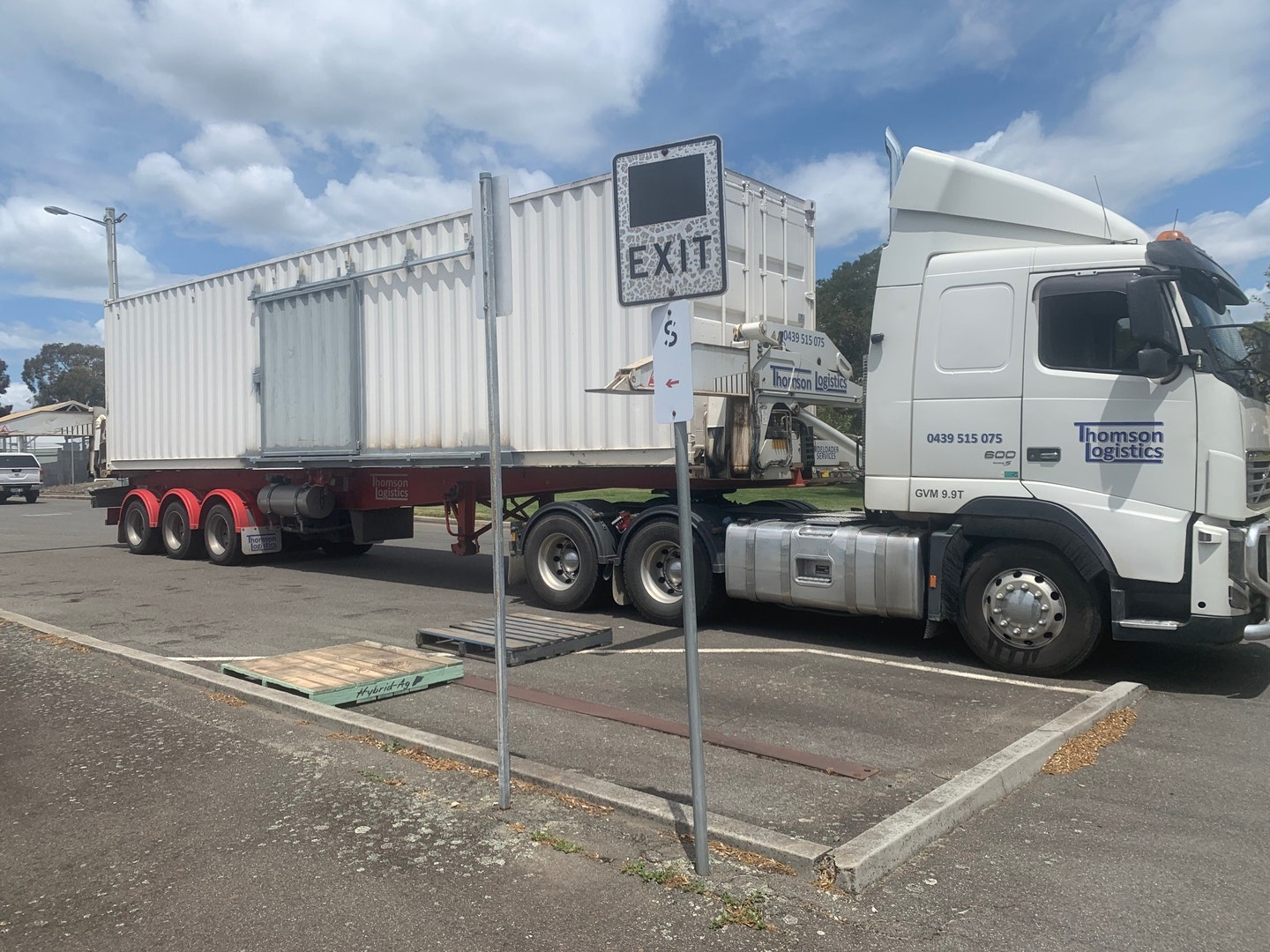 a shipping container being transported on a truck 