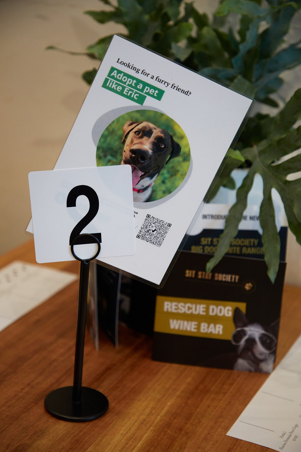 A table place with an image of an adoptable dog and a QR code