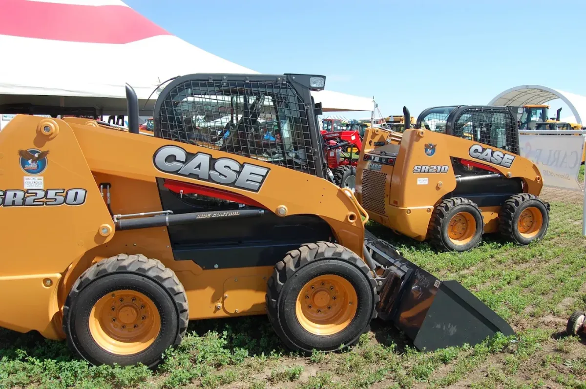 Case loaders photographed among the dealership equipment