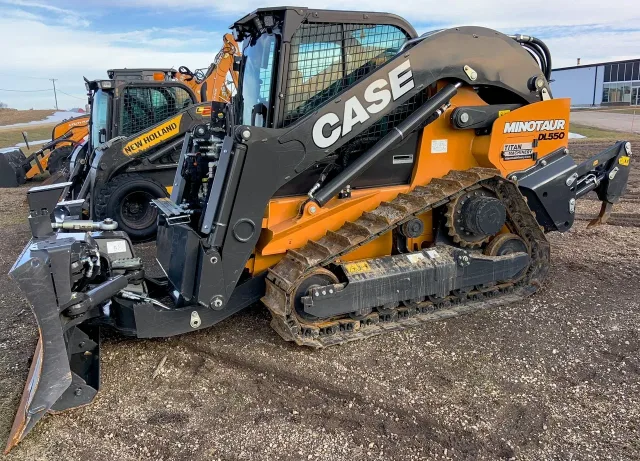 Case compact track loader with a grading blade