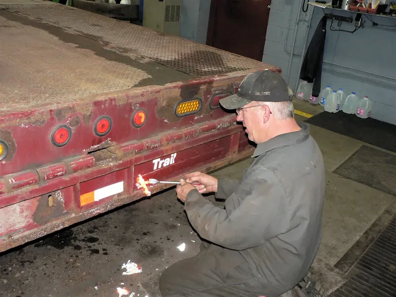 Mike Miller with the equipment-hauling truck, photographed in 2018.