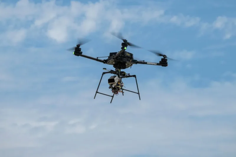A remotely piloted drone with four rotors carries a guidance and navigation experiment through flight maneuvers.