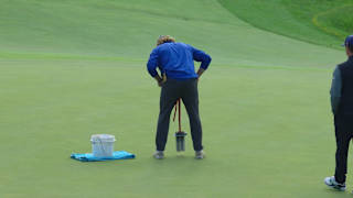 Agronomy staff move pin position prior to third playoff hole at RBC Canadian