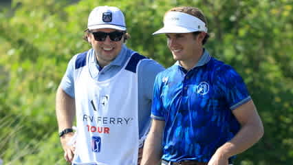 Boston Bruins' Charlie McAvoy caddies for James Nicholas at Orange County