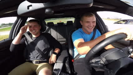 Players compete on the race track at the BMW Charity Pro-Am