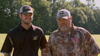 Brandon Crick tries to help Larry the Cable Guy's golf game
