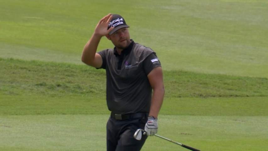 Ryan Moore attacks the pin on No. 14 at CIMB