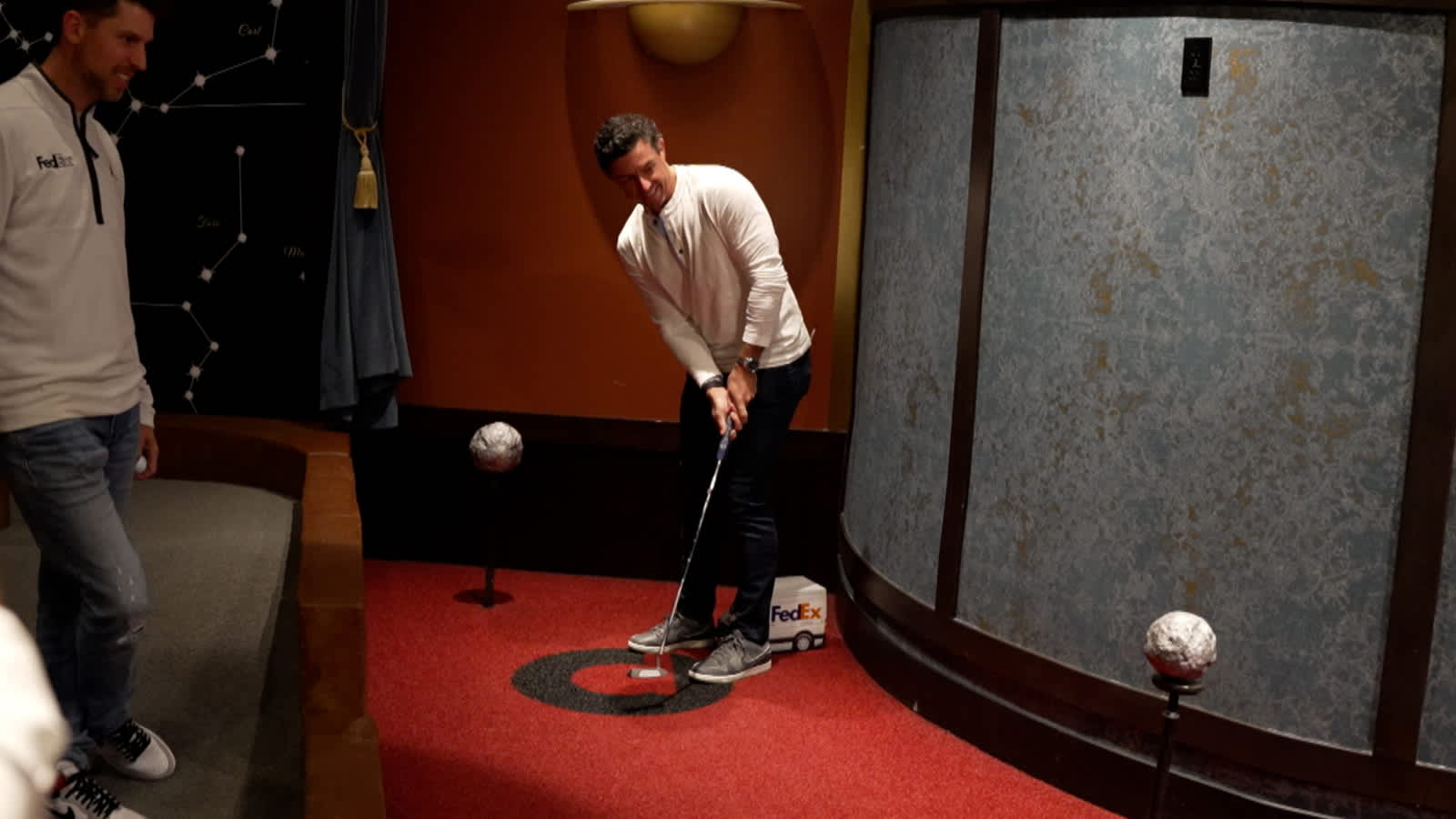 Rory McIlroy and Denny Hamlin work on their putting before Wells Fargo