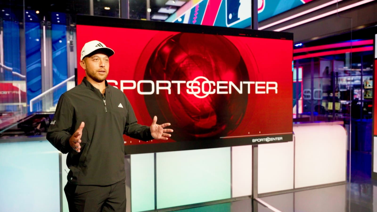 Xander Schauffele competes with Chris Berman during tour of ESPN