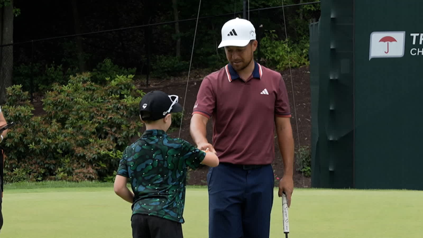 Xander Schauffele lets 8-year-old Zachary inside ropes during practice round