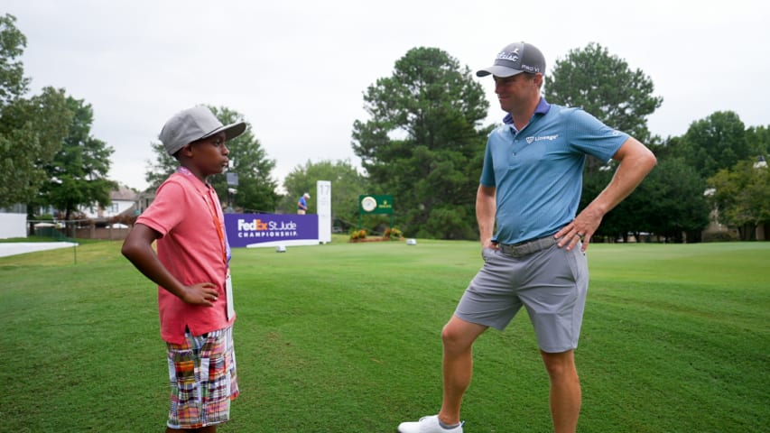 Justin Thomas walks with Quentin at TPC Southwind