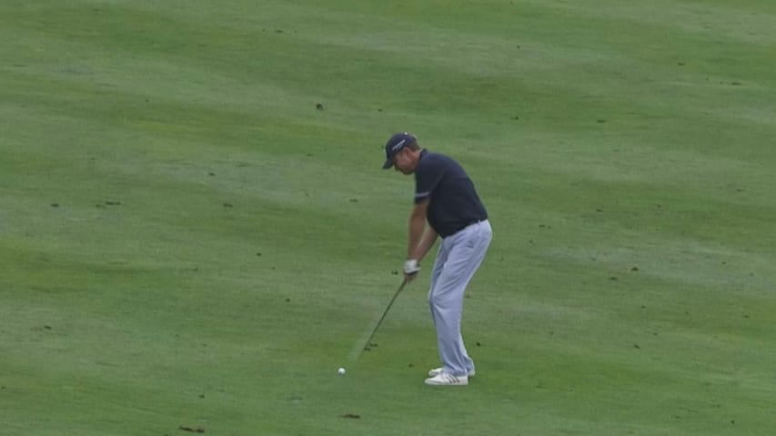 Davis Love III nudges the flagstick at Nature Valley First Tee Open