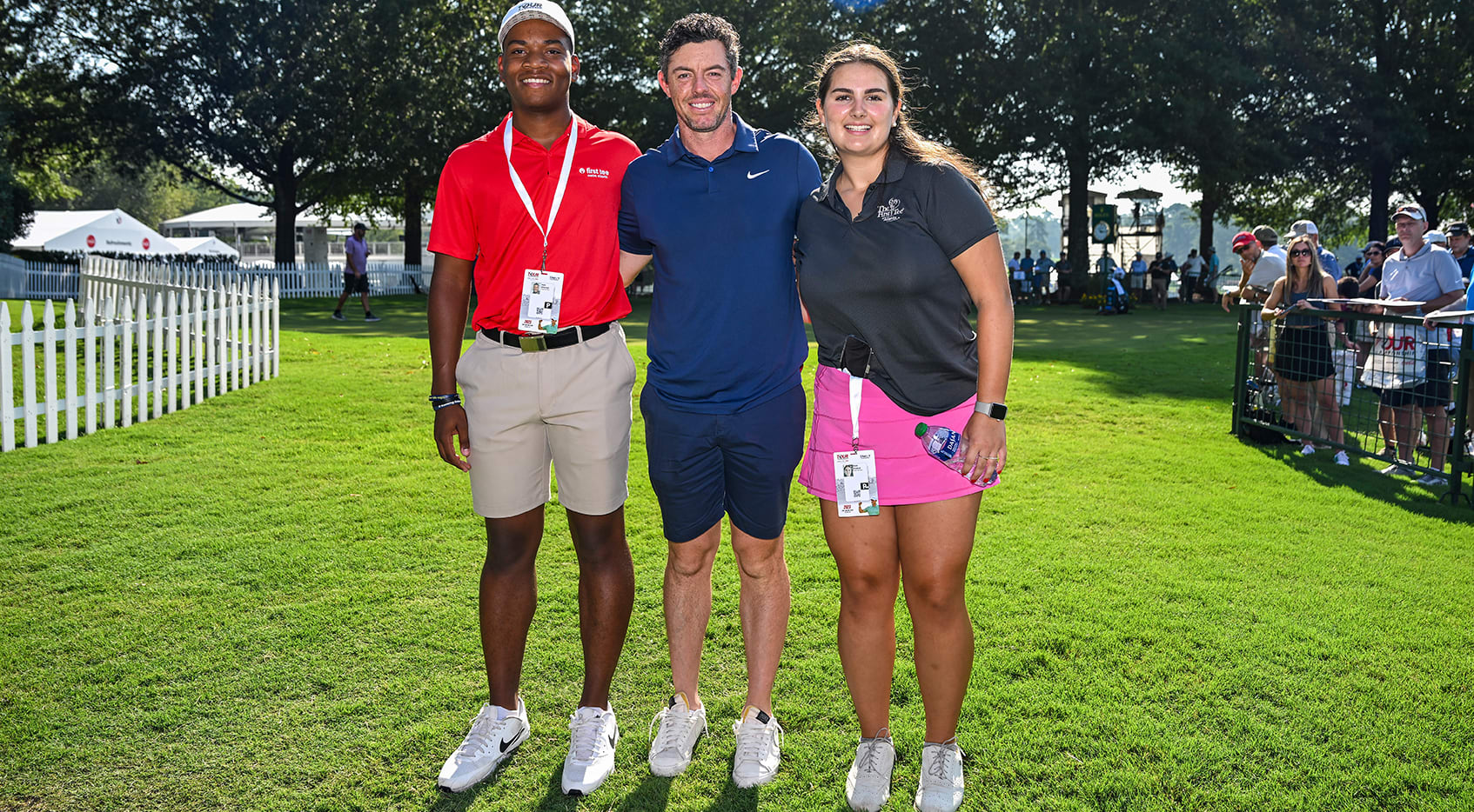 Rory McIlroy of Northern Ireland smiles with First Tee-Metro Atlanta participants Elsie Husted and Josh Mitchell, who are the 2023 HOPE Tee Shot honorees tasked with hitting the opening tee shots for the TOUR Championship, the third and final event of the FedExCup Playoffs, at East Lake Golf Club (Keyur Khamar/PGA TOUR)