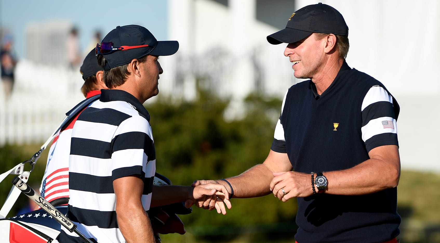 Steve Stricker, who captained the U.S. Team, talks with Kevin Kisner at the 2017 Presidents Cup at Liberty National Golf Club. (Chris Condon/PGA TOUR)