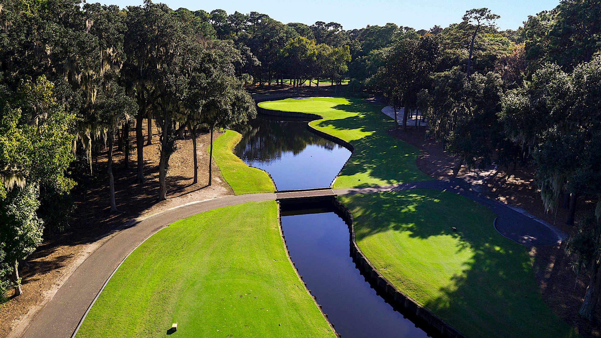 A classic Pete Dye risk/reward design. There is ample room on the right to bail out, and a hidden bunker behind the green can save your ball from a hungry lagoon.