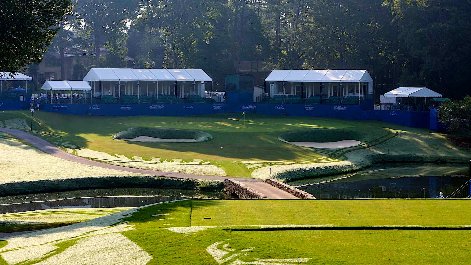 A great short par 3 playing downhill over a hazard to a raised fill pad green. Well defined internal contours on this green will challenge every class of player.