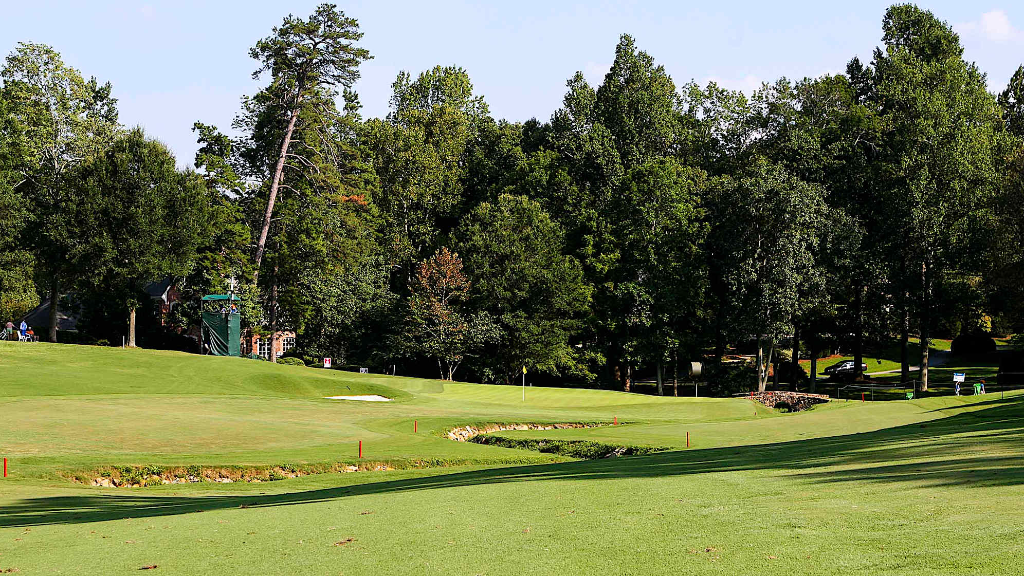 Three prominent bunkers on the right suggest a left to right tee shot. The player who skirts these bunkers will be rewarded with a shorter approach and better angle in the left to right sloping green.