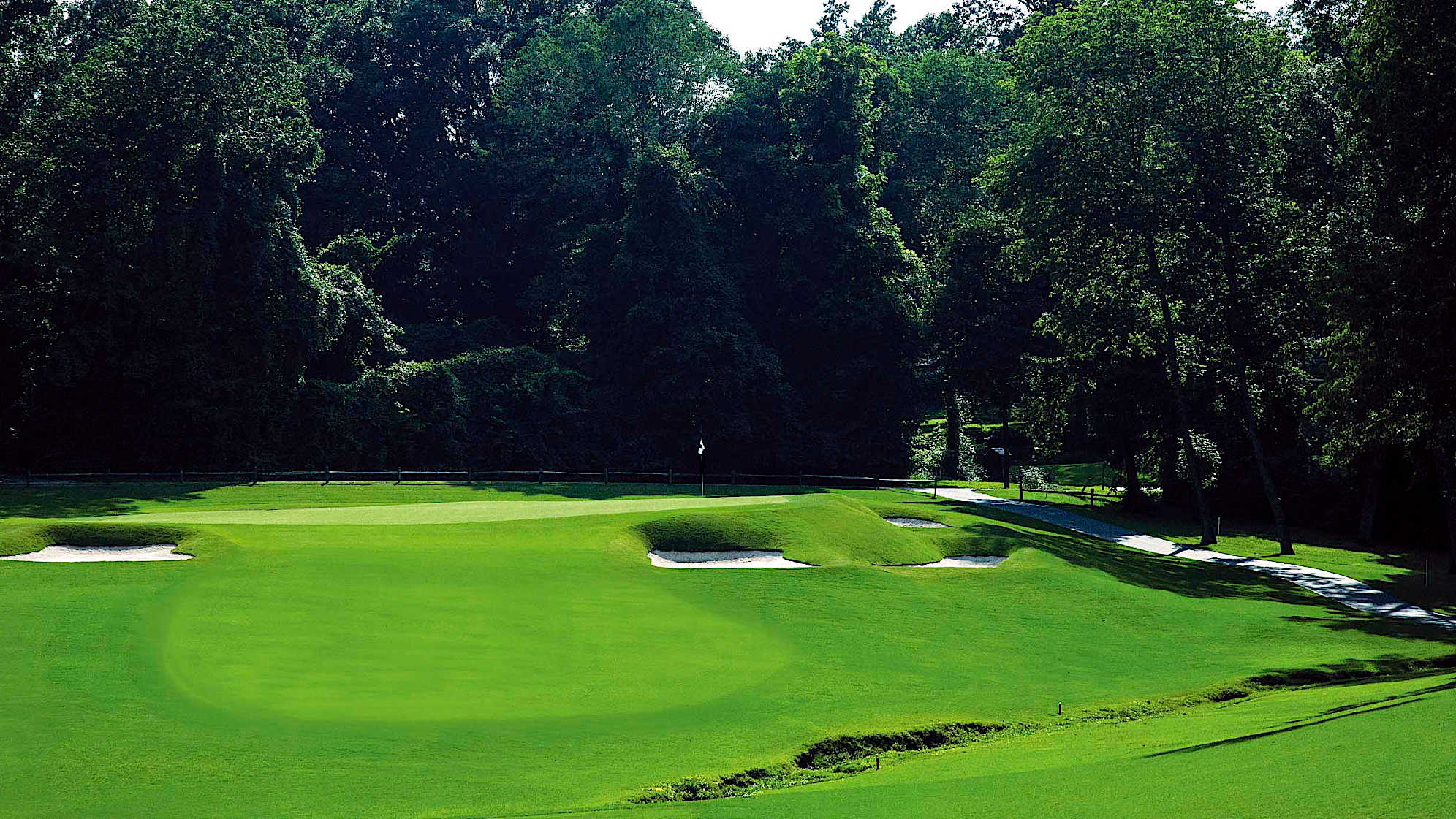 A uphill par 3 to a large green bordered by 3 restored bunkers in the steep right hand slope. Hole locations placed near the edge will require an accurate and confident stroke.