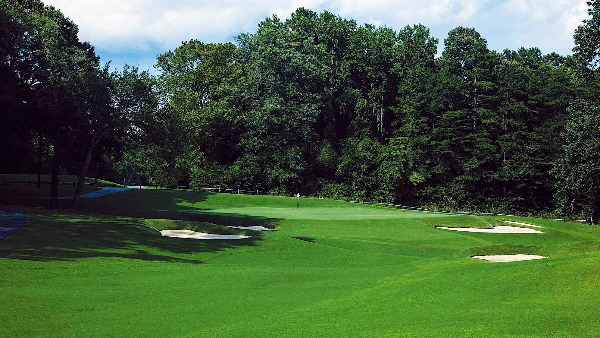 A new back tee restores the uphill and somewhat blind tee shot to the saddled fairway. Two new bunkers provide an interesting and straight lay-up to the plateau green.