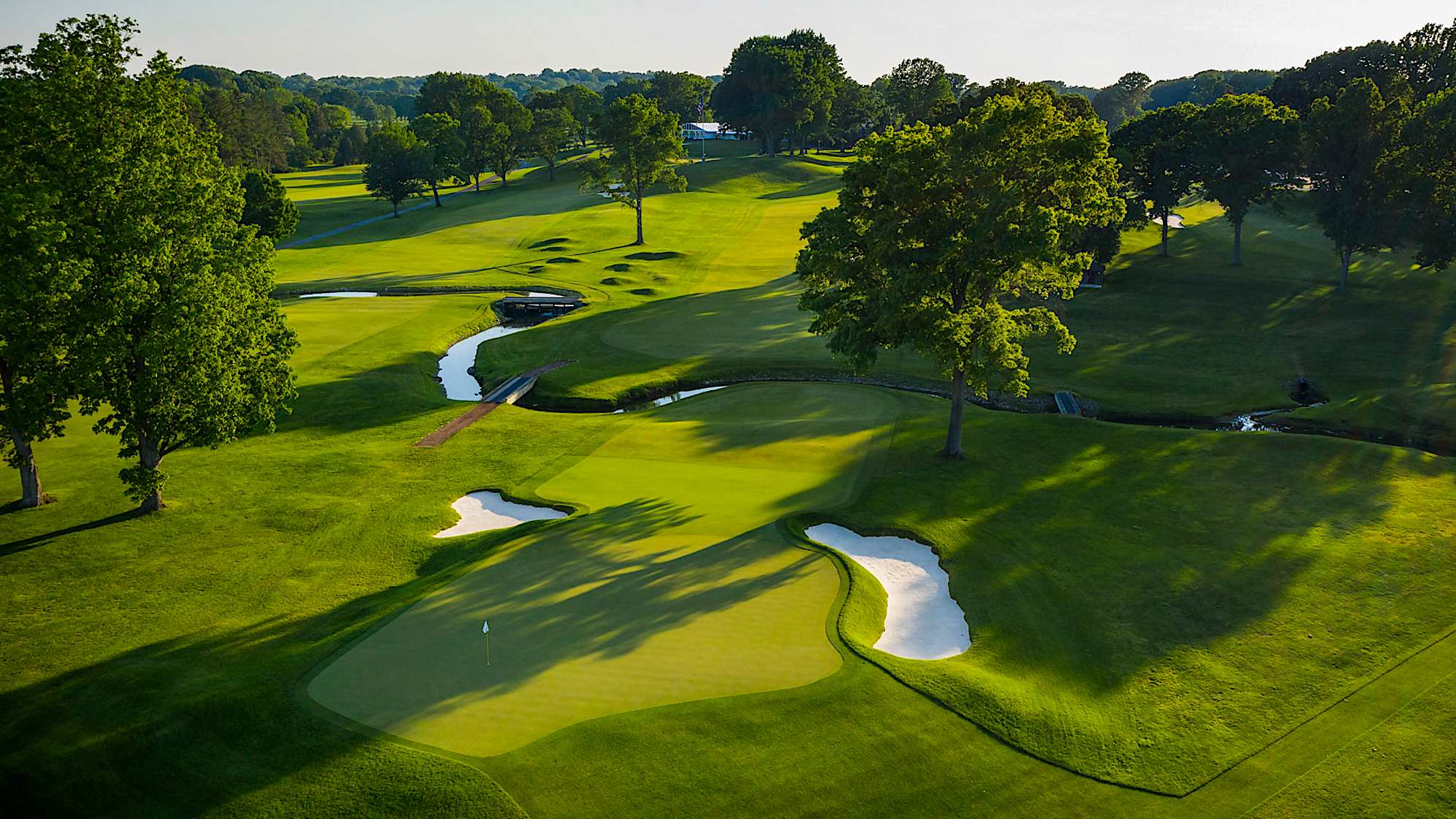The fairway on the par 4 10th slopes severely downhill at the 275-yard mark towards Allens Creek that crosses the fairway at 350 yards. Two greenside bunkers short and a run-off area on the back left corner forces players to aim for the middle of the green. Shots finding the putting surface will leave players with a good look at birdie as this is one of the flattest greens on the course. (Source: PGA of America)