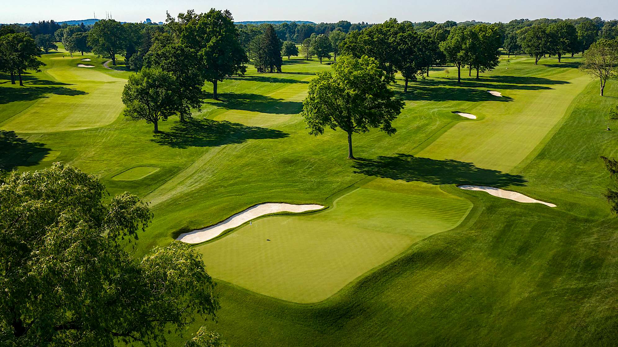 A well hit tee shot will take advantage of a slope in the fairway at the 275-yard mark leaving the player with a short shot into a receptive green. Two bunkers line the right side of the fairway: the first at 280, the second at 330. A miss left or long of the green will roll away significantly due to the tightly mown run-off area. (Source: PGA of America)
