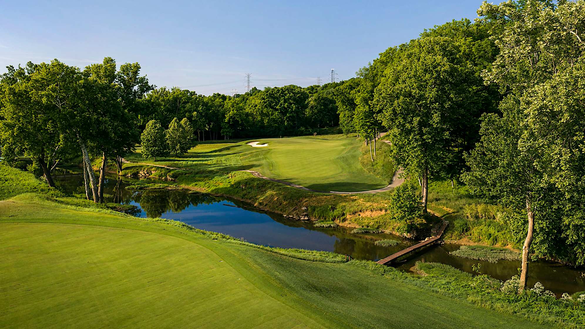 Long Shot: The name “Long Shot” refers not to distance but one’s chance of making a par on this difficult hole. It demands an accurate tee shot, and for some players will be something less than a driver as the aim is to get as close to Floyd’s Fork as one dares. Even after a good drive, players will still be looking at over 200 yards to a challenging green complex: A deep bunker guards the left side, a closely mown collection area lurks on the right. (Source: PGA of America)