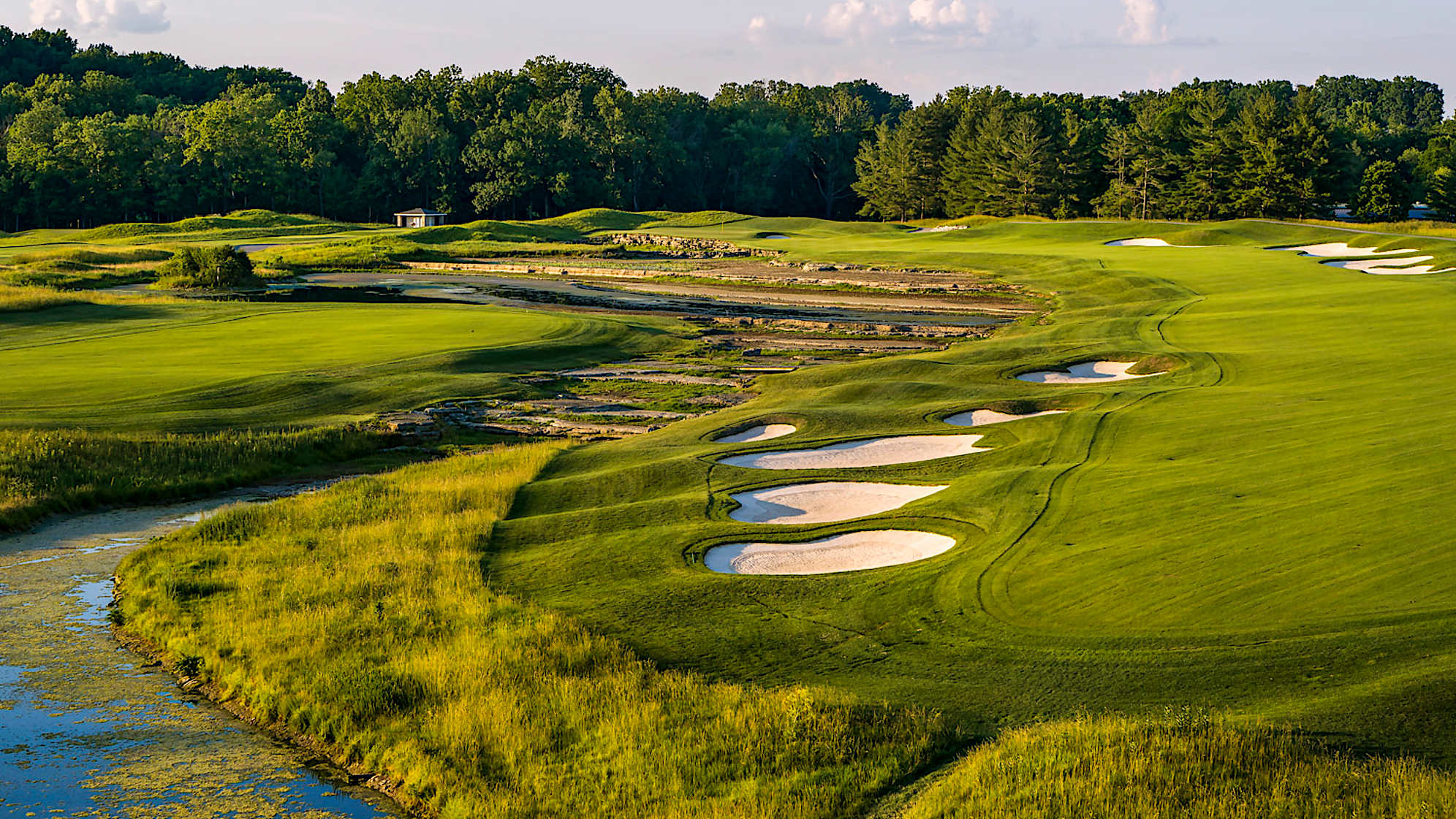 Genuine Risk: The split fairway sets up a classic risk vs. reward dilemma. Driving to the left shortens the hole by more than 50 yards, but the landing area is only 26 yards wide, surrounded by bluegrass rough, and guarded by water right; the approach from this island fairway is 210-230 yards, all over water. Driving to the right is longer but safer. With water along the front and left side of the green, it’s a brave player who attacks from any angle. (Source: PGA of America)